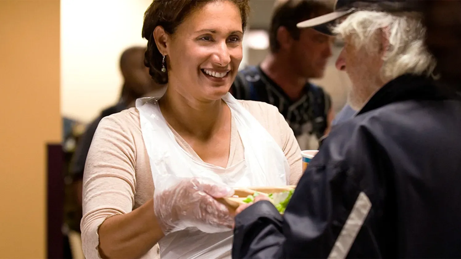 Choristers serving meals at a community shelter.
